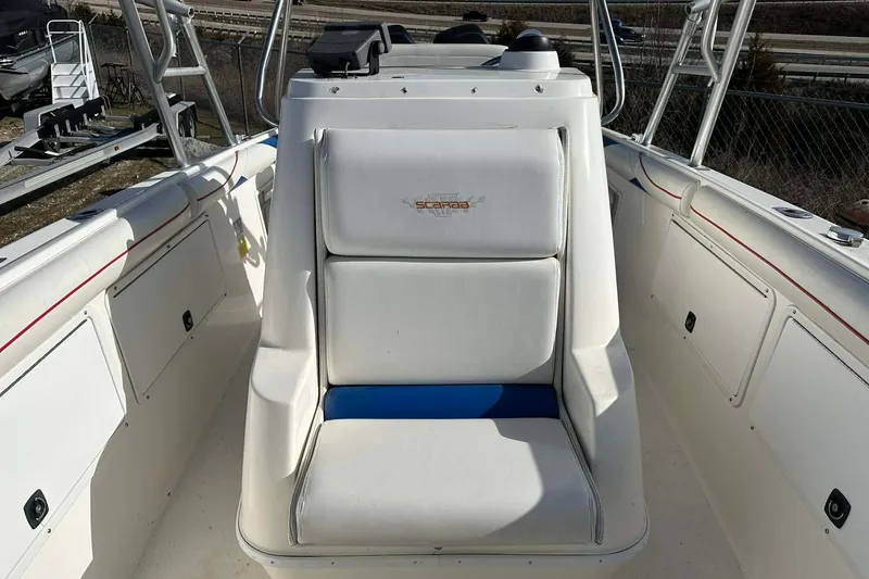 Slide: The Image of 1995 Wellcraft 302 Scarab Sport boat interior with white seating and console. - 5