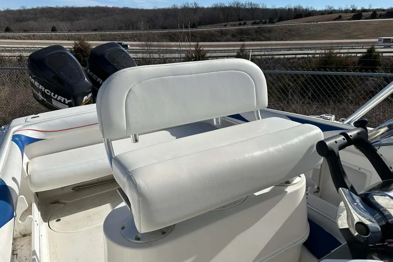 Slide: The Image of 1995 Wellcraft 302 Scarab Sport boat interior with white seating and dual Mercury engines. - 6