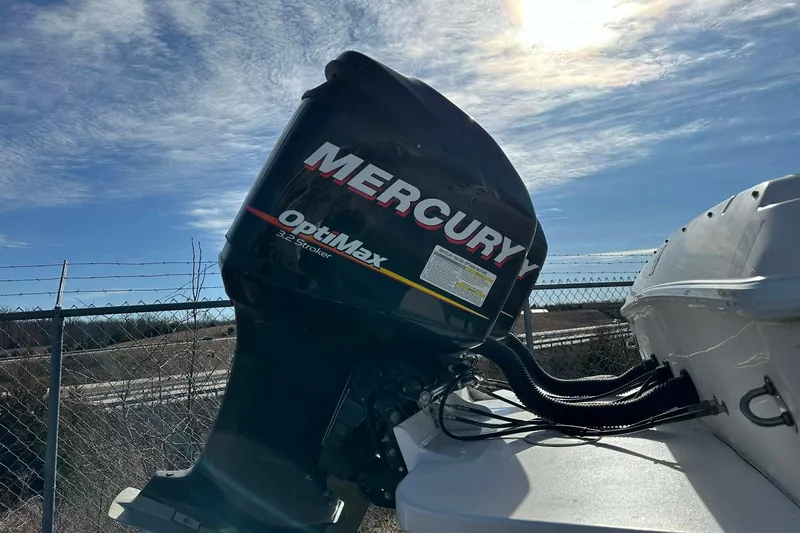 Slide: The Image of 1995 Wellcraft 302 Scarab Sport with Mercury OptiMax 3.2 Stroker engine under sunny sky. - 8