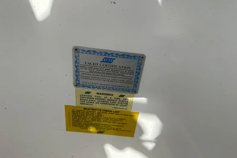 Slide: The Image of 1995 Wellcraft 302 Scarab Sport yacht certification and safety warning labels. - 9