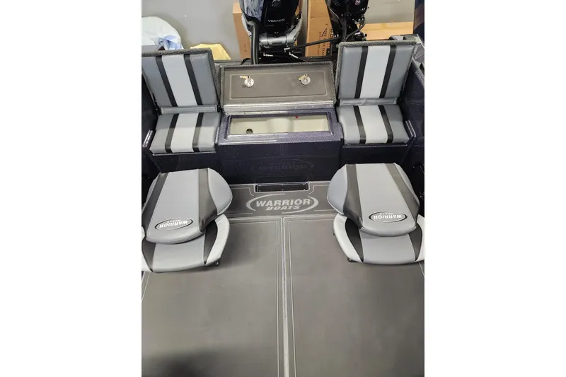 Slide: The Image of 2026 Warrior V208 boat interior with gray seating and storage compartments. - 10