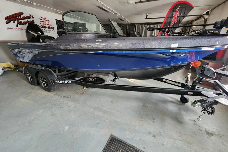 Slide: The Image of 2026 Warrior V208 boat in showroom, blue exterior, on trailer. - 16