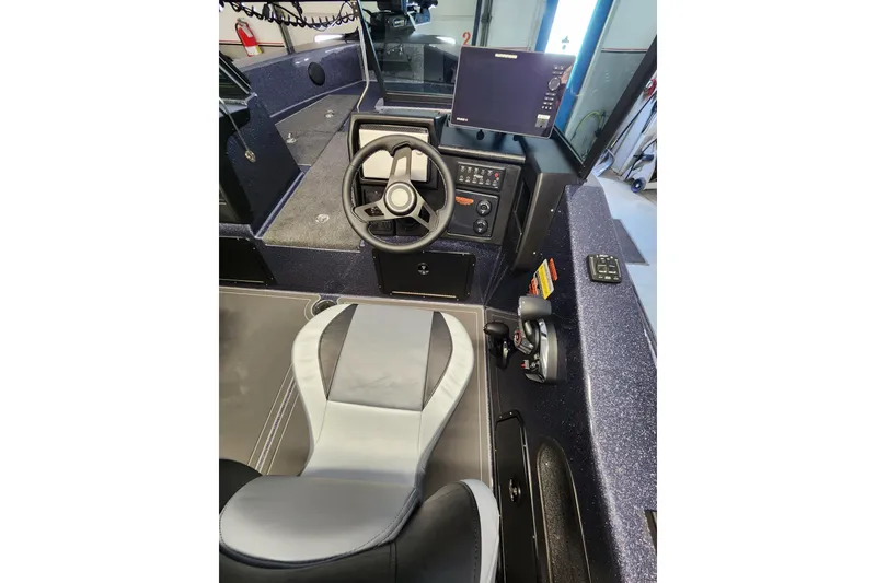 Slide: The Image of 2026 Warrior V208 boat interior with steering wheel, control panel, and seating. - 9