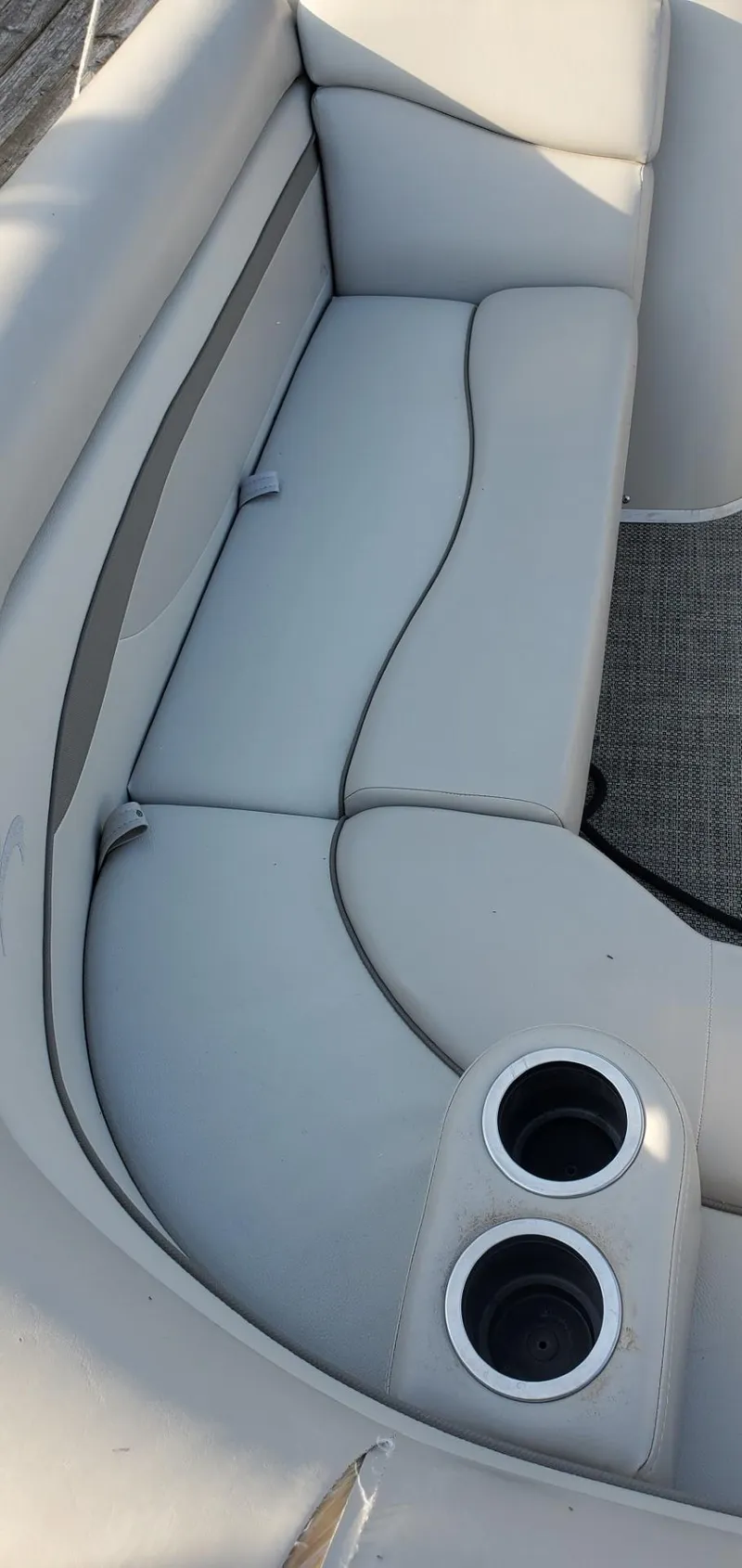 Slide: The Image of Interior of a 2015 Bennington 24SSRX with gray upholstery and cup holders. - 13