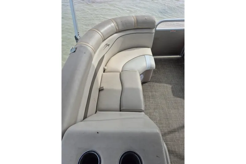 Slide: The Image of 2015 Bennington 24SSRX pontoon boat interior with beige seating and cup holders. - 18