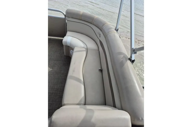Slide: The Image of 2015 Bennington 24SSRX pontoon boat with beige seating by the water. - 19