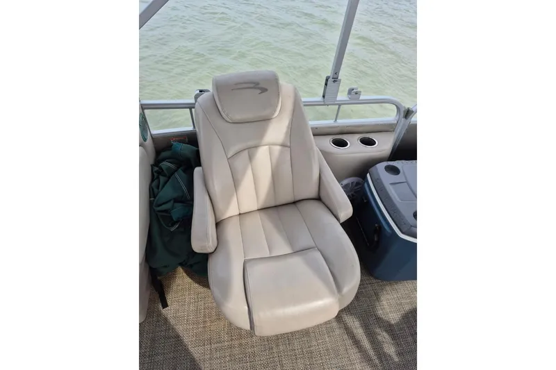 Slide: The Image of Comfortable seating on a 2015 Bennington 24SSRX pontoon boat with cup holders and cooler. - 24