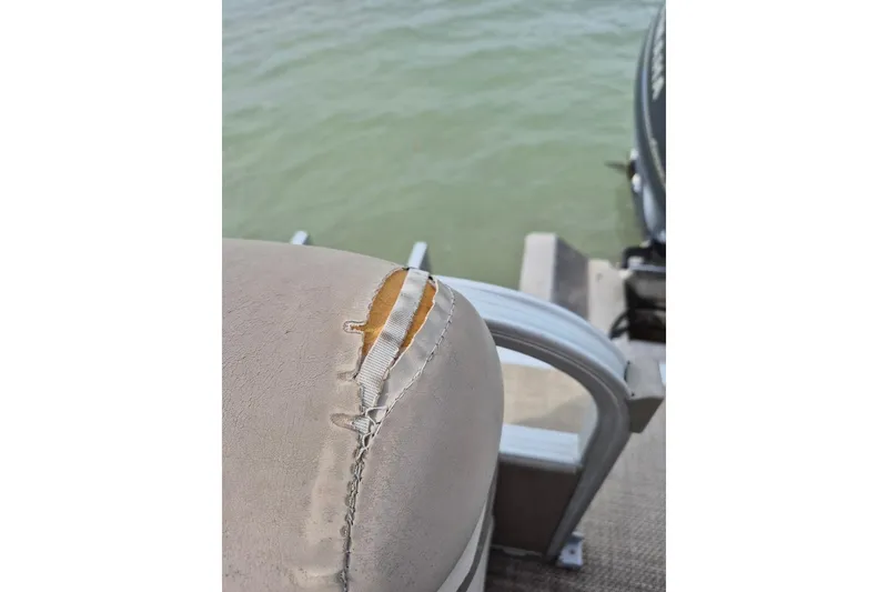 Slide: The Image of Torn seat on 2015 Bennington 24SSRX boat near water. - 25