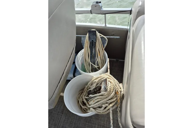 Slide: The Image of Boat interior with ropes and anchor in buckets on a 2015 Bennington 24SSRX. - 27