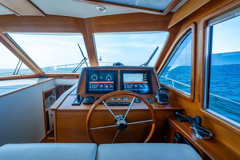 Slide: The Image of Helm of 2017 Grand Banks 44 Eastbay SX yacht with navigation screens and ocean view. - 29