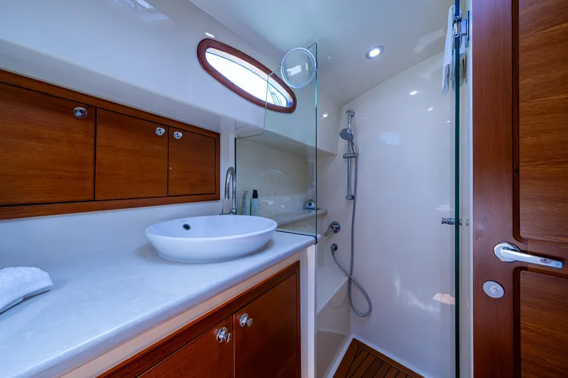 Slide: The Image of Luxurious bathroom in 2017 Grand Banks 44 Eastbay SX yacht with modern fixtures and wooden accents. - 45