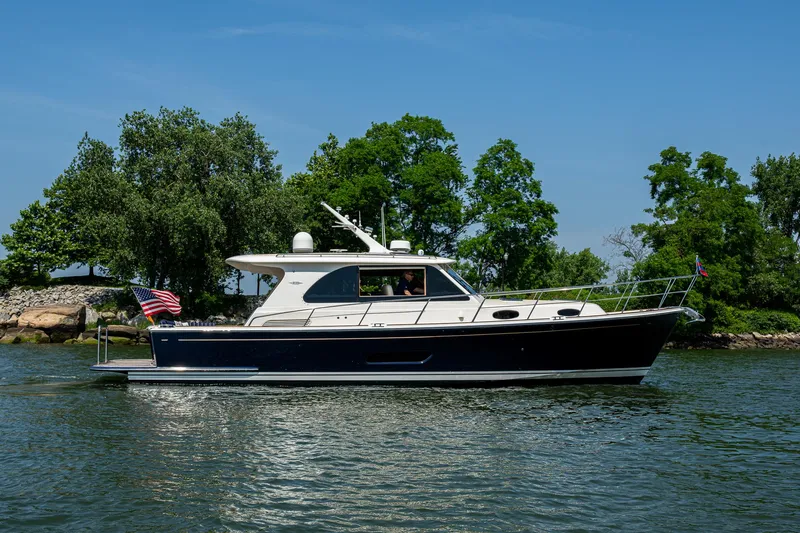Slide: The Image of 2017 Grand Banks 44 Eastbay SX yacht cruising on a scenic waterway. - 5