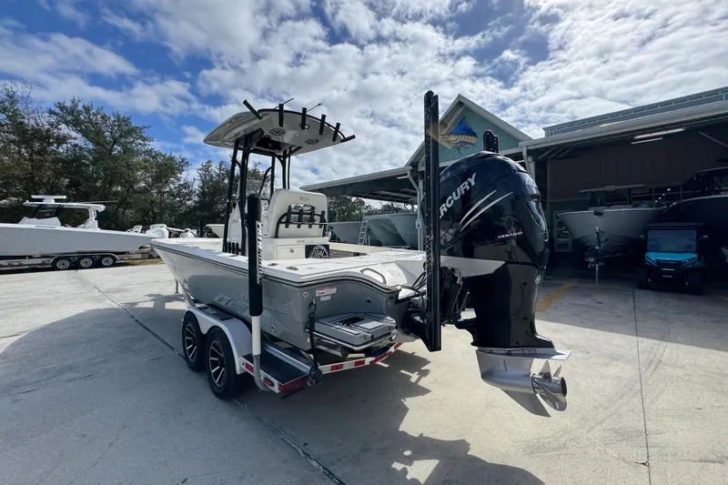 Slide: The Image of 2023 Pathfinder 2500 Hybrid boat with Mercury engine in a marina setting. - 15