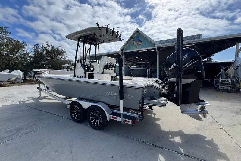 Slide: The Image of 2023 Pathfinder 2500 Hybrid boat with Mercury engine on trailer, parked outdoors. - 16