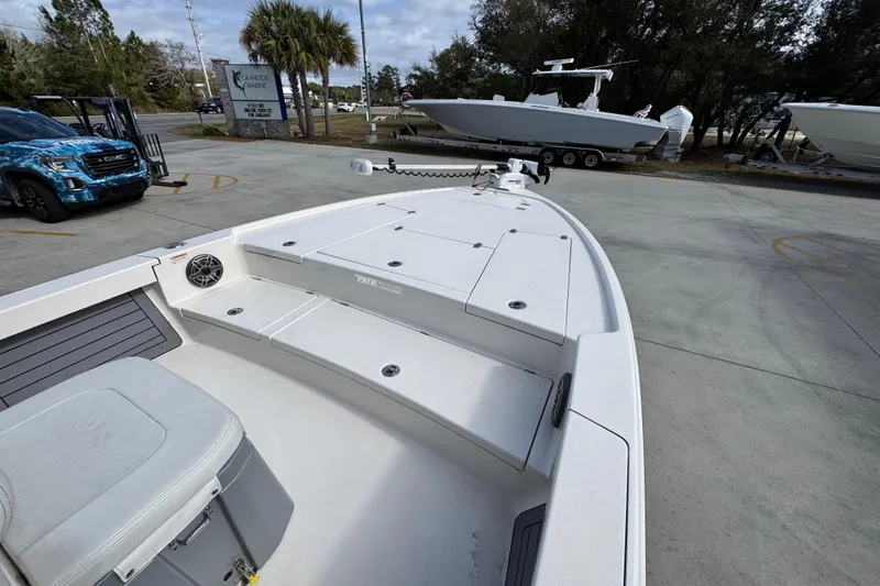 Slide: The Image of 2023 Pathfinder 2500 Hybrid boat on display at a marina with surrounding vehicles. - 17