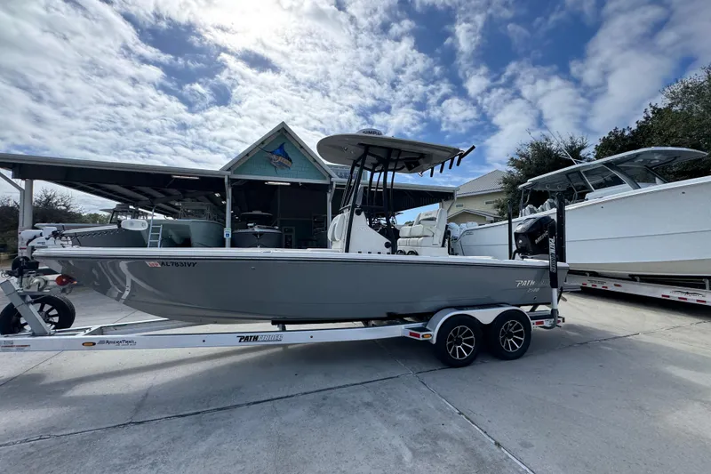 Slide: The Image of 2023 Pathfinder 2500 Hybrid boat on trailer under cloudy sky. - 2