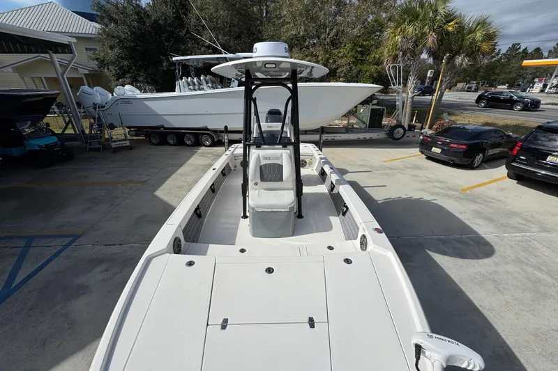 Slide: The Image of 2023 Pathfinder 2500 Hybrid boat in a parking lot, showcasing its spacious deck. - 21