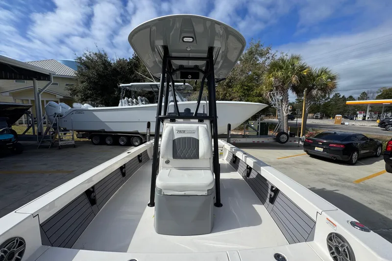 Slide: The Image of 2023 Pathfinder 2500 Hybrid boat with T-top, parked outdoors under blue sky. - 22