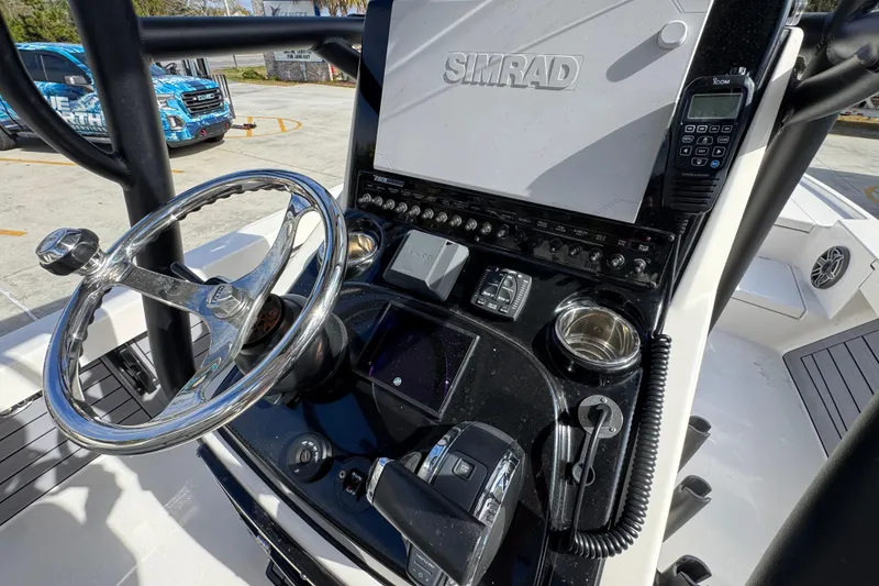 Slide: The Image of 2023 Pathfinder 2500 Hybrid boat console with steering wheel and navigation equipment. - 33