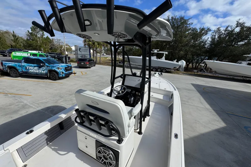 Slide: The Image of 2023 Pathfinder 2500 Hybrid boat with T-top and rod holders in a parking lot. - 36