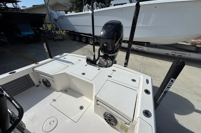 Slide: The Image of 2023 Pathfinder 2500 Hybrid boat with outboard motor, docked on a trailer. - 37