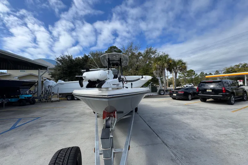 Slide: The Image of 2023 Pathfinder 2500 Hybrid boat on trailer in parking lot under cloudy sky. - 5