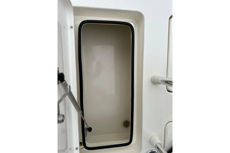 Slide: The Image of Open storage compartment on 2014 Maverick 17 HPX-V boat. - 11