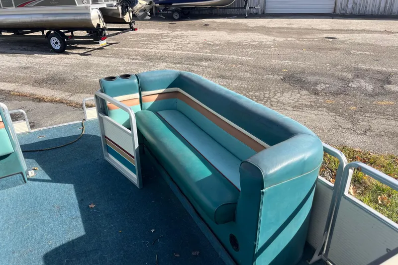Slide: The Image of 1989 Harris FloteBote 240 Classic pontoon boat with teal seating and cup holders. - 2