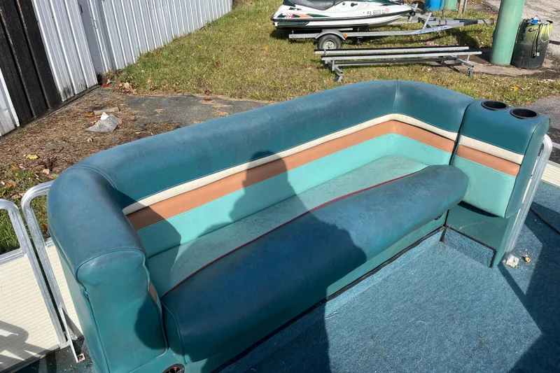 Slide: The Image of 1989 Harris FloteBote 240 Classic boat interior with teal and tan seating. - 3