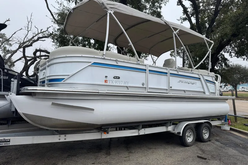 The Image of 2004 Monterey 298SS Super Sport boat on trailer, parked outdoors. - 1