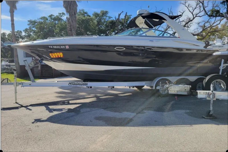 Slide: The Image of 2004 Monterey 298SS Super Sport boat on trailer, sunny day, price displayed. - 11