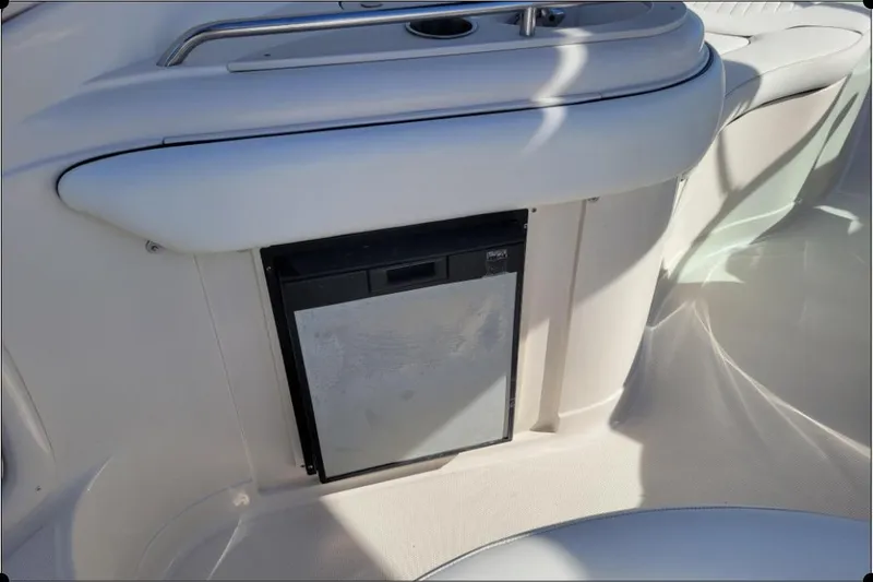 Slide: The Image of 2004 Monterey 298SS Super Sport boat interior with built-in mini fridge. - 14