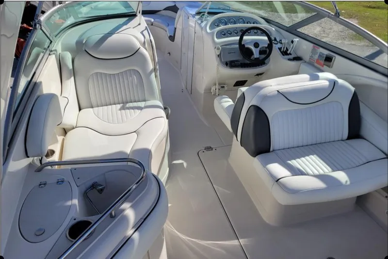 Slide: The Image of 2004 Monterey 298SS Super Sport boat interior with white seating and steering console. - 15