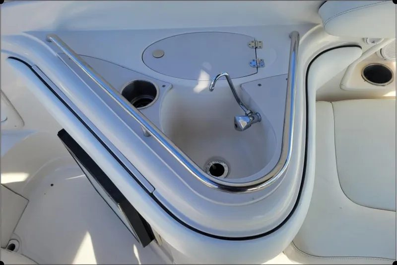 Slide: The Image of 2004 Monterey 298SS Super Sport boat sink with chrome faucet and railing. - 17