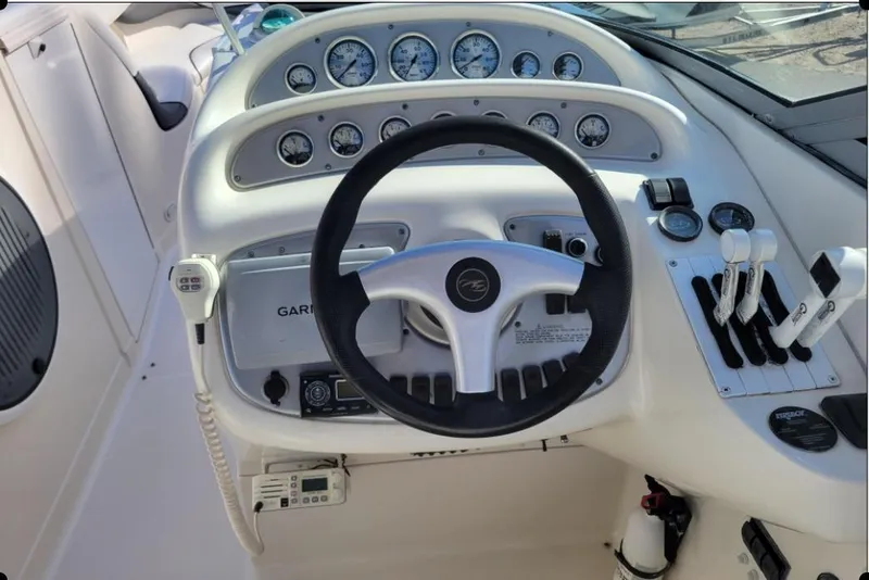 Slide: The Image of Cockpit of 2004 Monterey 298SS Super Sport boat with steering wheel and control panel. - 19