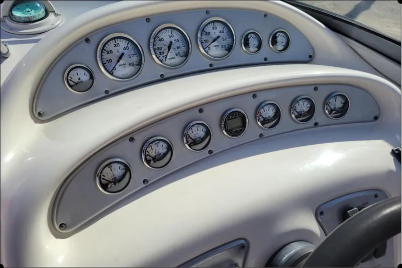 Slide: The Image of Dashboard of a 2004 Monterey 298SS Super Sport boat with multiple gauges and controls. - 21