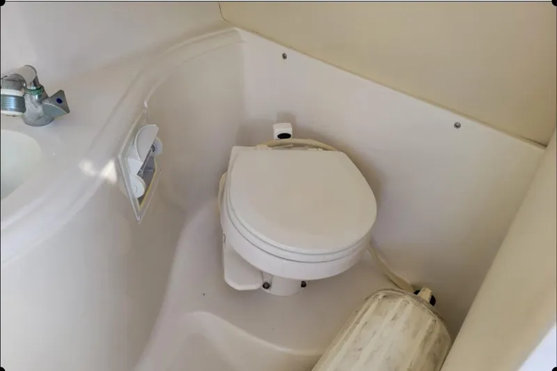 Slide: The Image of 2004 Monterey 298SS Super Sport boat bathroom with toilet and sink. - 22