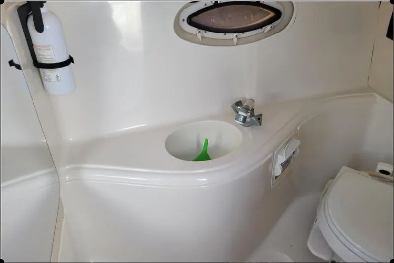 Slide: The Image of Interior of a 2004 Monterey 298SS Super Sport boat bathroom with sink and toilet. - 23