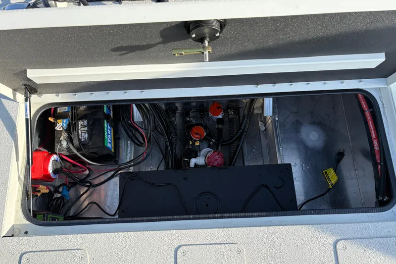 Slide: The Image of 2026 Ranger RB200 boat battery compartment with wiring and components. - 12