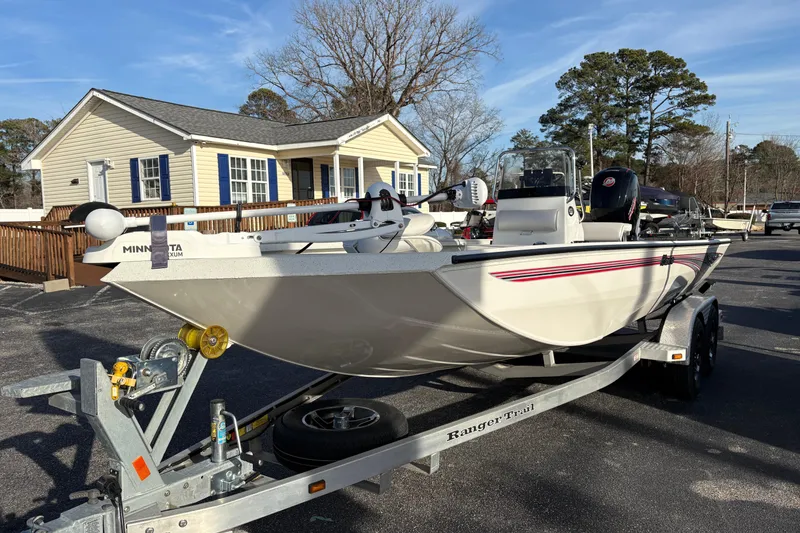 Slide: The Image of 2026 Ranger RB200 boat on trailer, parked near a house, under clear blue sky. - 5
