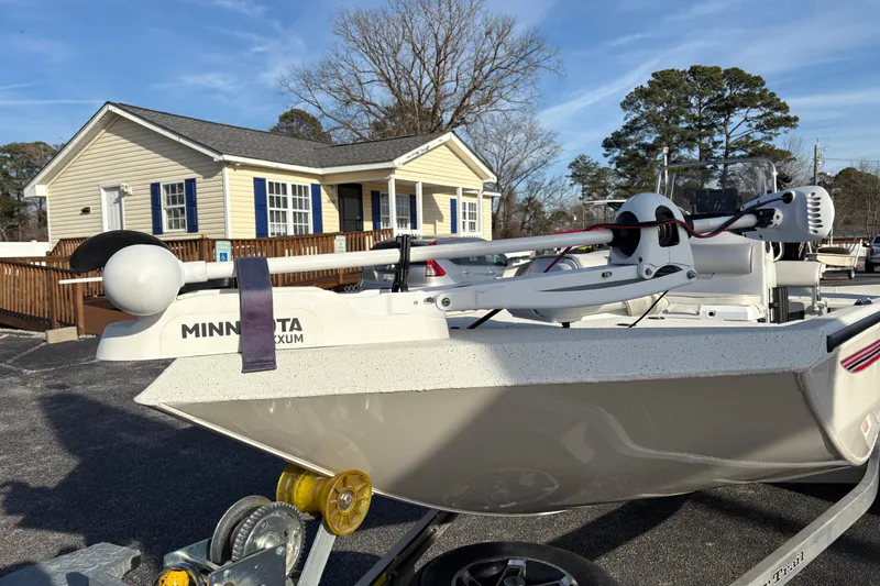 Slide: The Image of 2026 Ranger RB200 boat with Minn Kota trolling motor, parked near a house. - 9