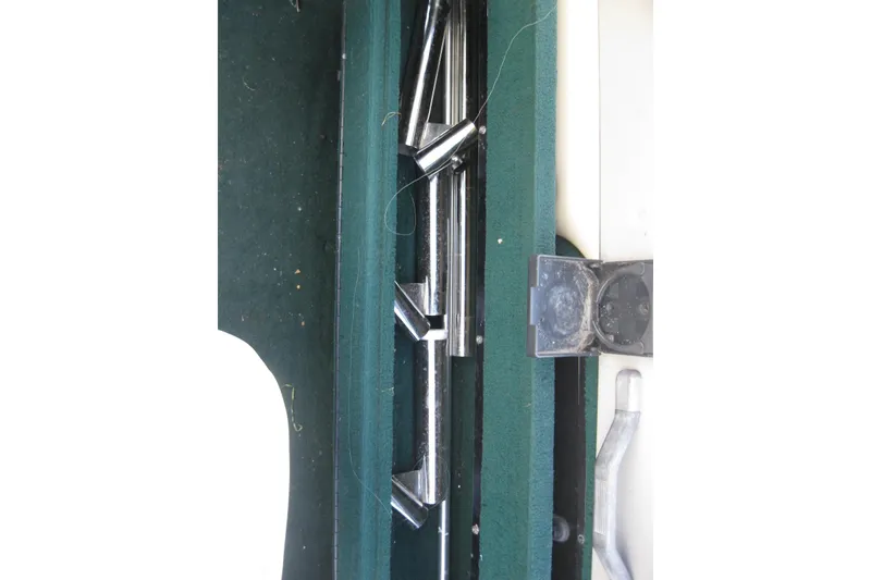 Slide: The Image of Interior view of a 1999 Starcraft Pro-Elite 2000 boat with green carpet and metal components. - 11