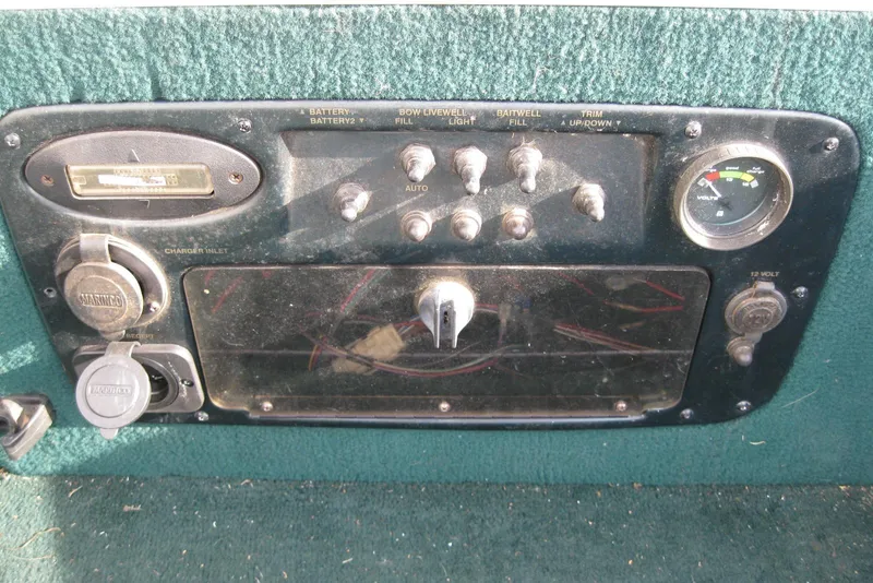 Slide: The Image of Control panel of a 1999 Starcraft Pro-Elite 2000 boat with switches and gauges. - 19