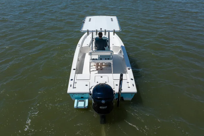 Slide: The Image of 2018 Pathfinder 2400 TRS boat on water, rear view with outboard motor. - 12