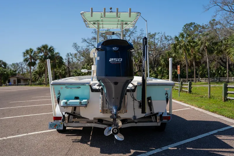 Slide: The Image of 2018 Pathfinder 2400 TRS boat with Yamaha 250 engine in a sunny parking lot. - 2