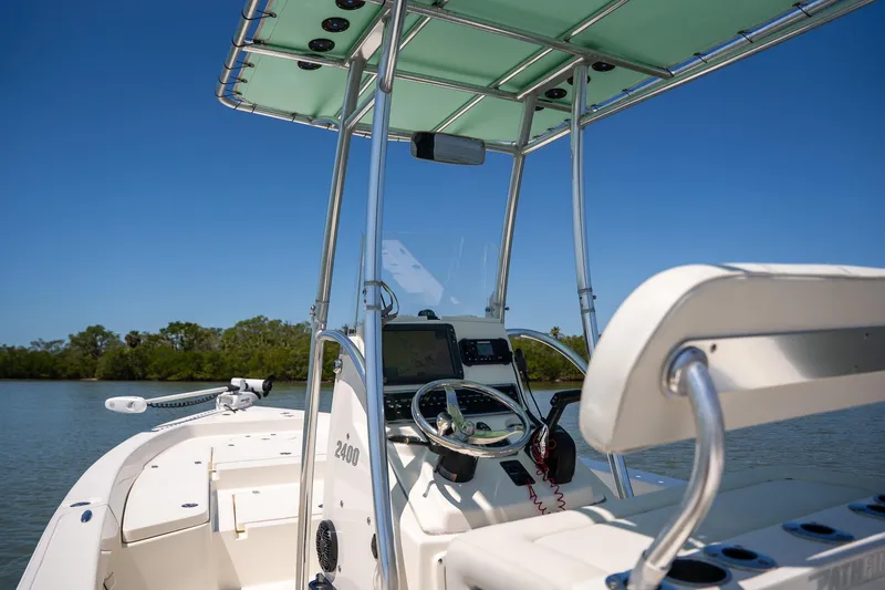 Slide: The Image of 2018 Pathfinder 2400 TRS boat interior with steering wheel and navigation equipment. - 32