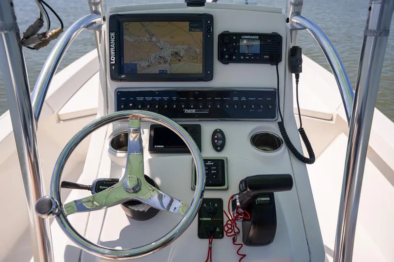 Slide: The Image of 2018 Pathfinder 2400 TRS boat console with steering wheel, navigation, and control systems. - 33