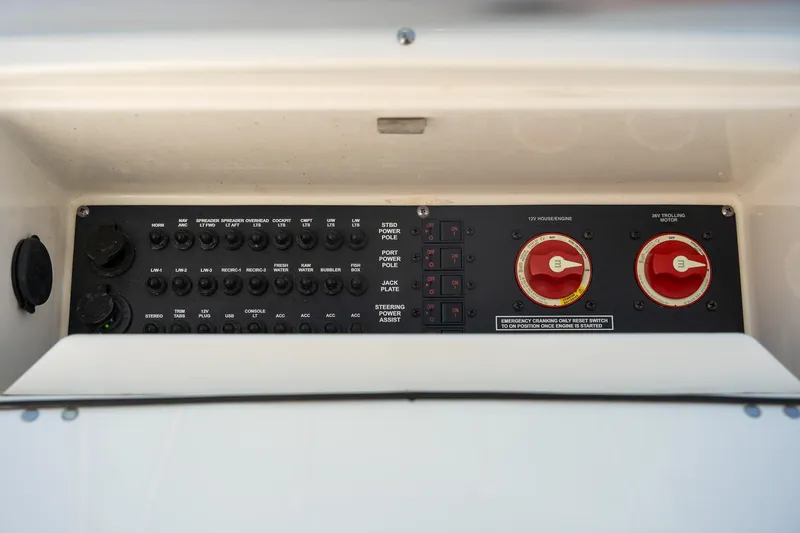 Slide: The Image of Control panel of a 2018 Pathfinder 2400 TRS boat with switches and dials. - 36