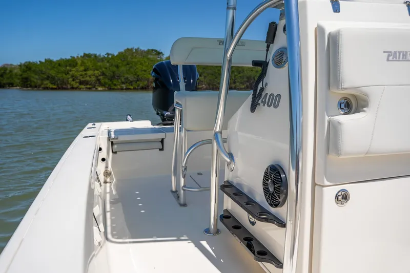 Slide: The Image of 2018 Pathfinder 2400 TRS boat interior with seating and console, on calm water. - 40