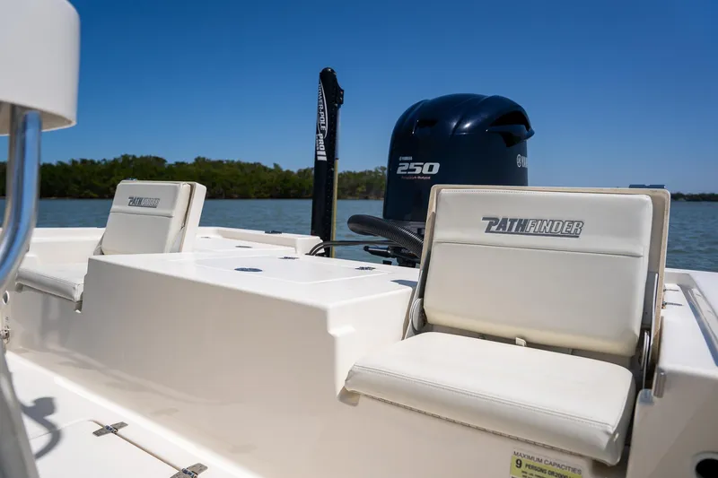 Slide: The Image of 2018 Pathfinder 2400 TRS boat with Yamaha 250 engine, white seating, on calm water. - 45